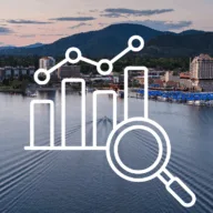 North Idaho real estate market trends October 2025 - data analysis graphic over Lake Coeur d'Alene showing Kootenai County housing market statistics